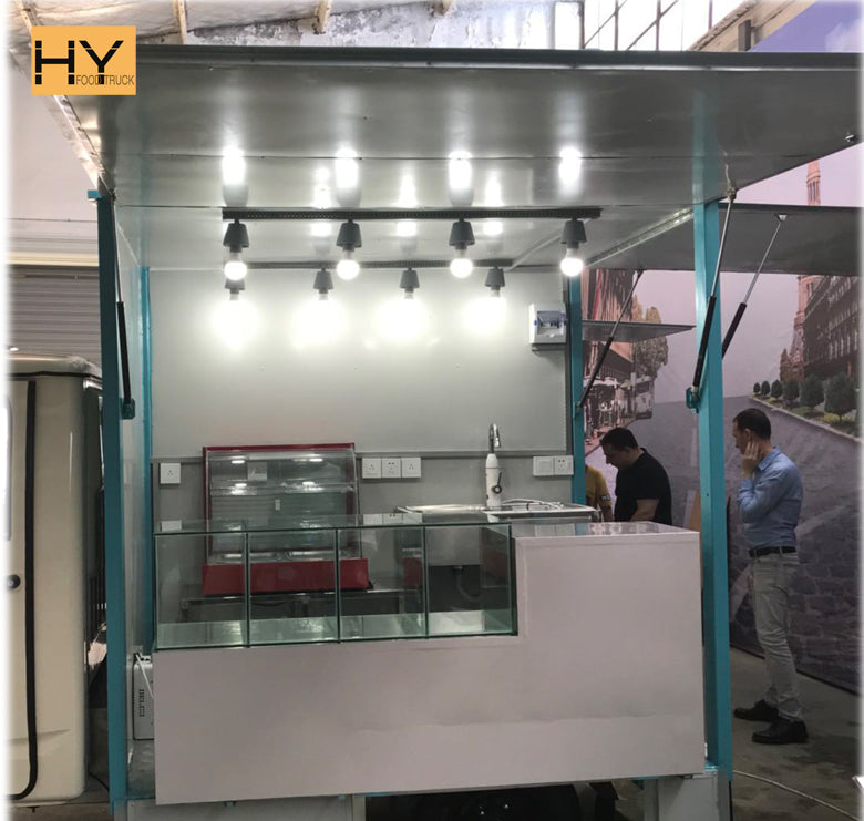 Taco Truck Cost: Low-budget electric tricycle taco cart with display area and lights.