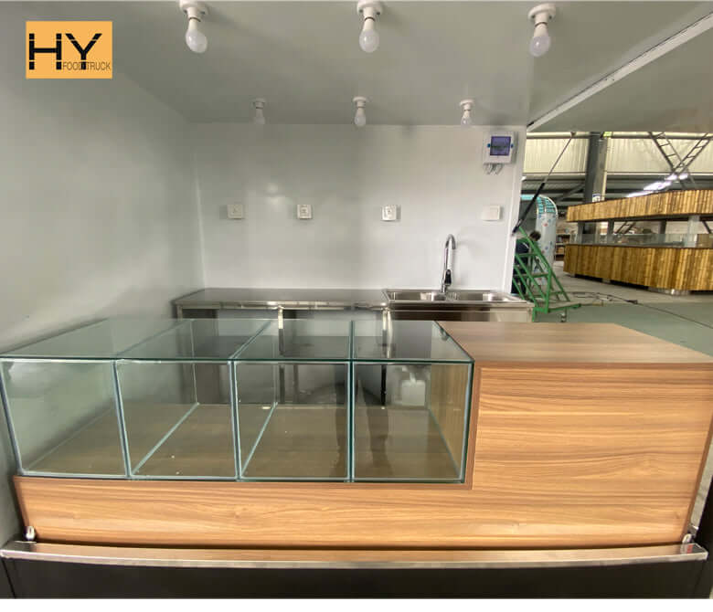 Compact food counter design inside an electric taco truck highlighting taco truck cost and business setup.