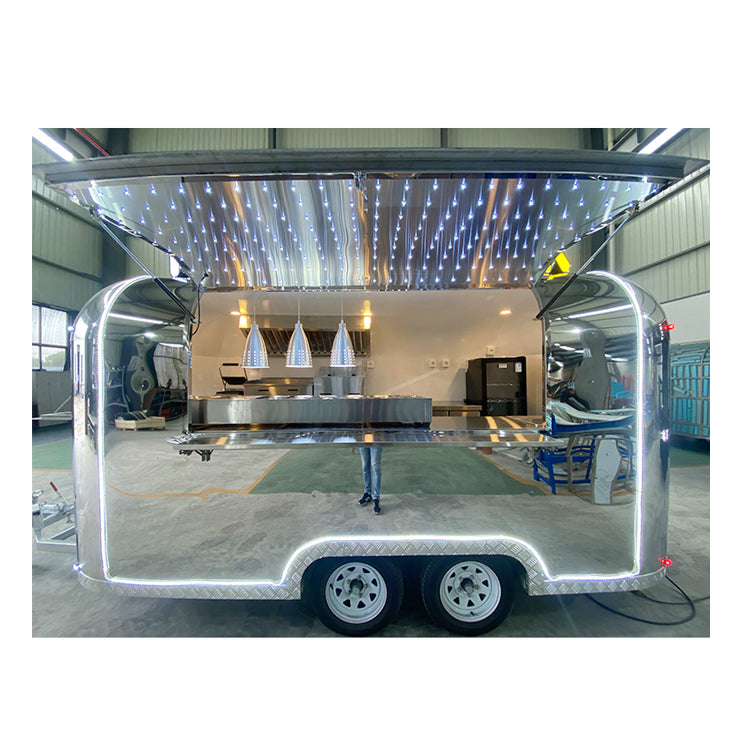 13FT Airstream Food Trailers with stainless steel exterior and LED lighting, ideal for commercial settings.