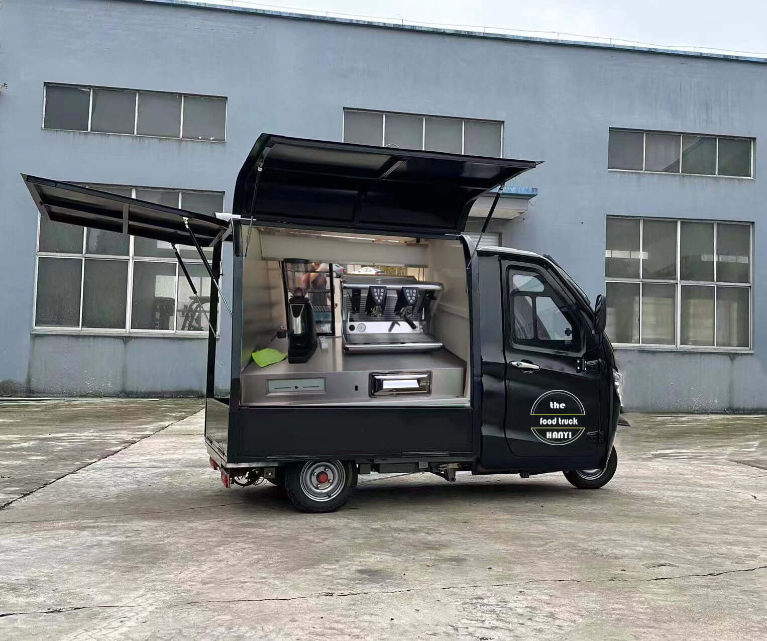 Mobile Coffee Shop on Wheels featuring a fully equipped electric coffee tricycle with open side for serving coffee.
