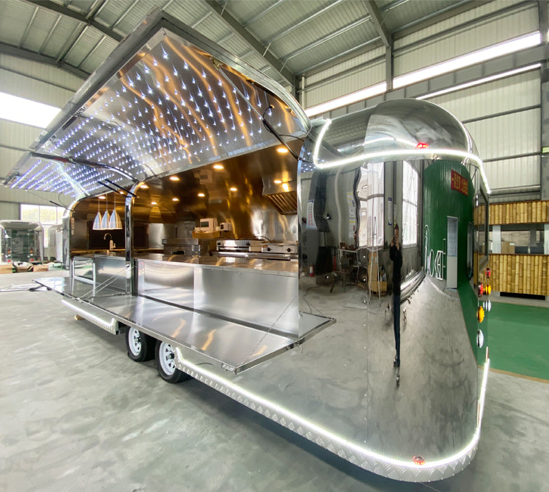 Food Trailer Airstream with LED lights and stainless steel kitchen interior in modern design.