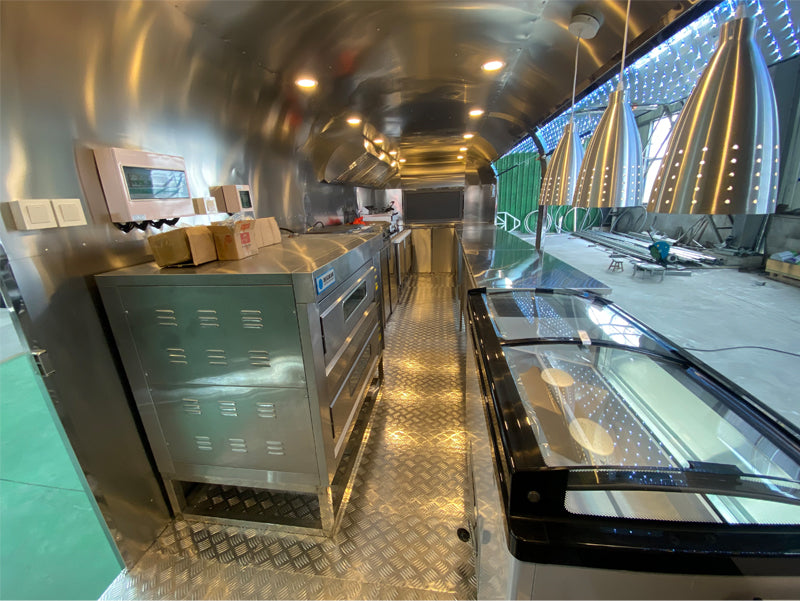 Food Trailer Airstream interior with stainless steel kitchen equipment and modern design