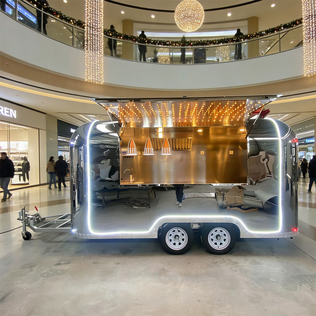 13FT Airstream Food Trailers showcasing a stainless steel kitchen in a commercial space with LED lighting.